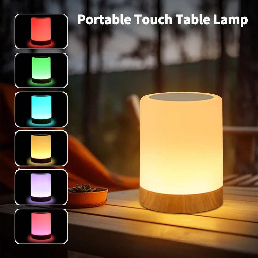 Portable touch table lamp with color-changing options on a wooden surface.